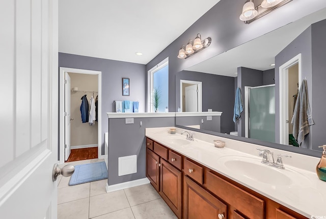 bathroom with tile patterned flooring, vanity, and a shower with shower door