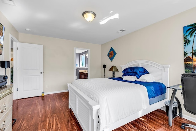 bedroom featuring dark hardwood / wood-style floors and connected bathroom