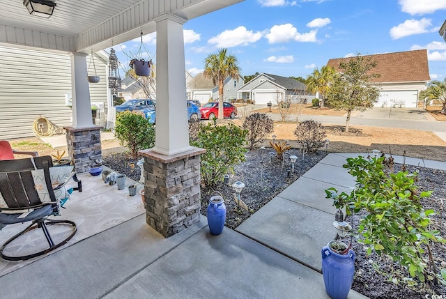 view of patio / terrace featuring a garage and covered porch