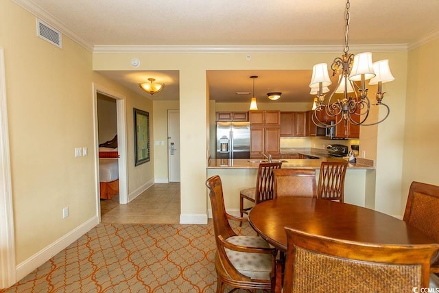 tiled dining space featuring a notable chandelier and ornamental molding