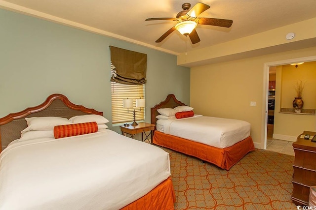 tiled bedroom featuring ceiling fan