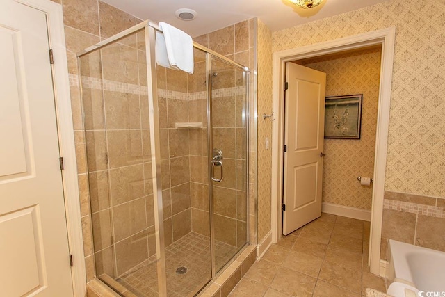 bathroom with independent shower and bath and tile patterned flooring