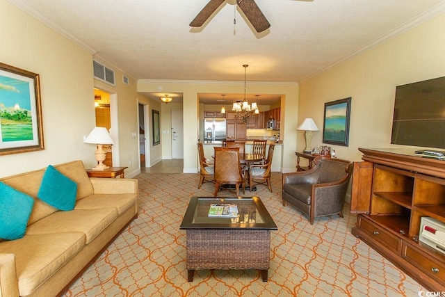 living room with ornamental molding, ceiling fan with notable chandelier, light colored carpet, and a textured ceiling