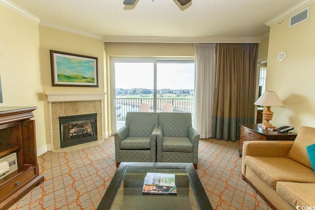 carpeted living room featuring crown molding, a fireplace, and ceiling fan