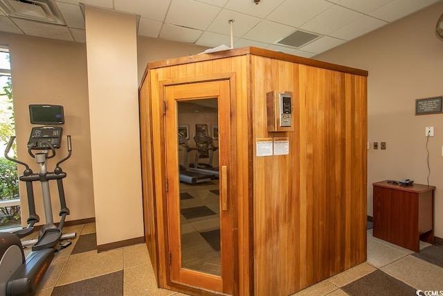 hall featuring plenty of natural light and a paneled ceiling