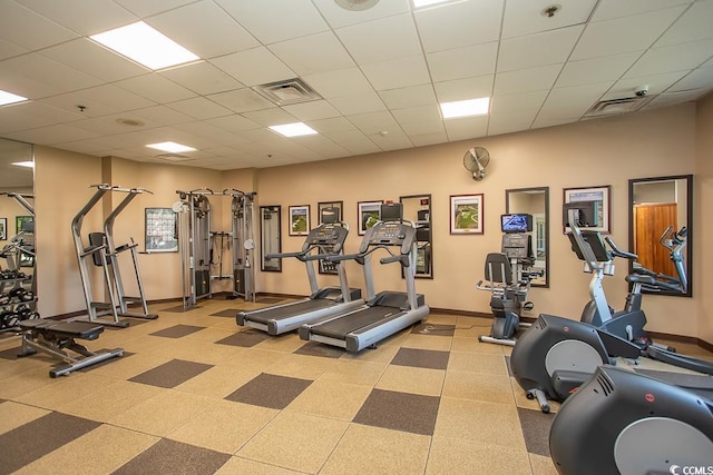 gym with a paneled ceiling