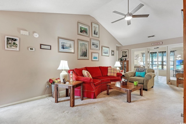 living room with lofted ceiling, visible vents, light carpet, ceiling fan, and baseboards