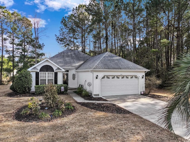 single story home featuring roof with shingles, driveway, and an attached garage