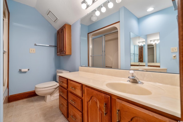 bathroom with lofted ceiling, tile patterned flooring, vanity, an enclosed shower, and toilet