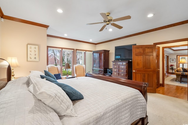 carpeted bedroom with ceiling fan and ornamental molding