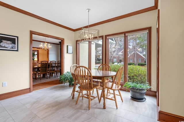 dining area with ornamental molding and a chandelier