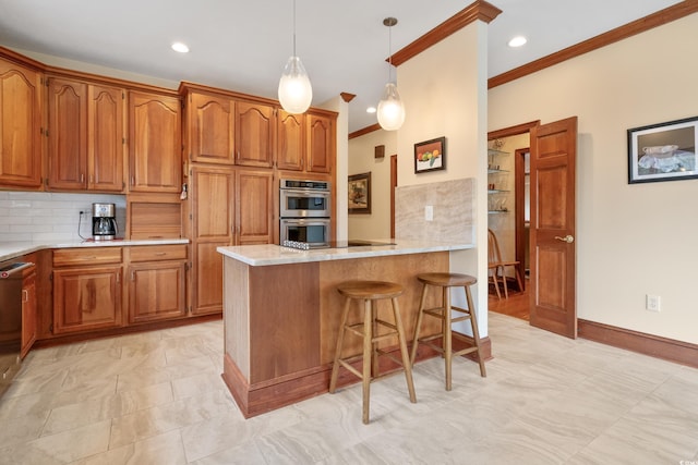 kitchen with tasteful backsplash, crown molding, stainless steel double oven, and a kitchen breakfast bar