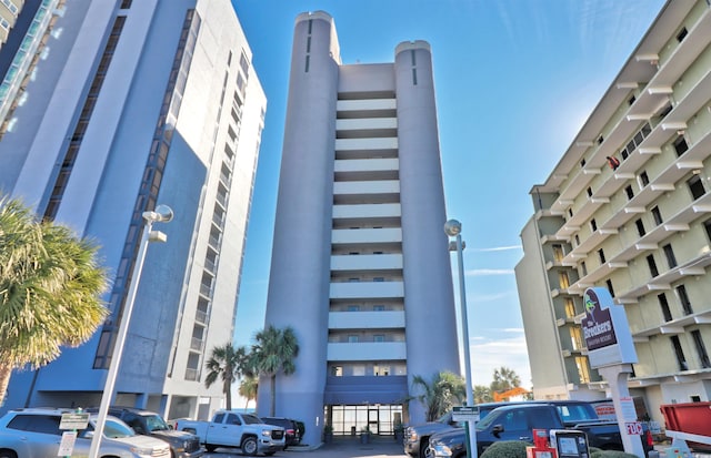 view of building exterior featuring uncovered parking