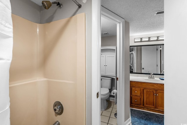 full bathroom with tile patterned flooring, vanity,  shower combination, toilet, and a textured ceiling