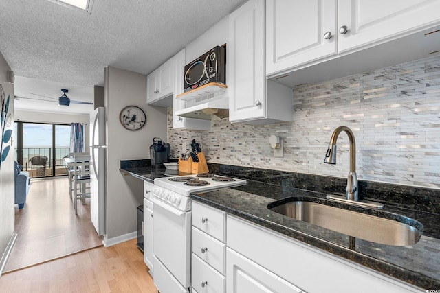 kitchen featuring white cabinetry, sink, white electric stove, and dark stone countertops