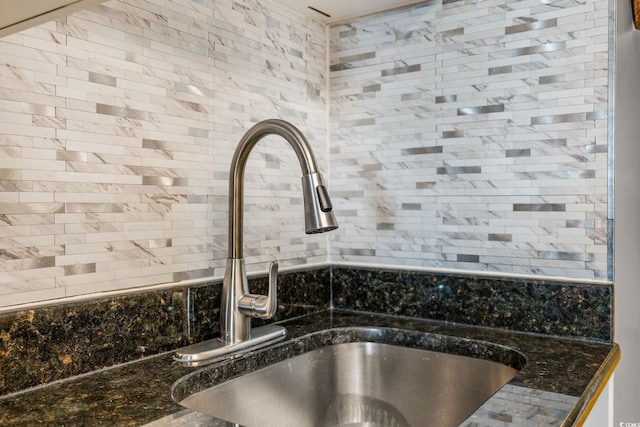 room details featuring sink and dark stone counters