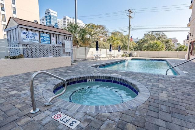 view of pool featuring a community hot tub and a patio