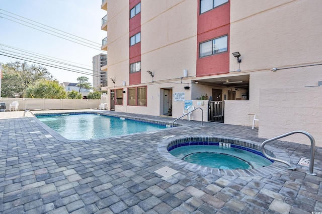 view of pool featuring a community hot tub and a patio