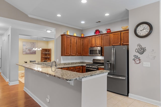 kitchen featuring a breakfast bar, tasteful backsplash, kitchen peninsula, stainless steel appliances, and light stone countertops