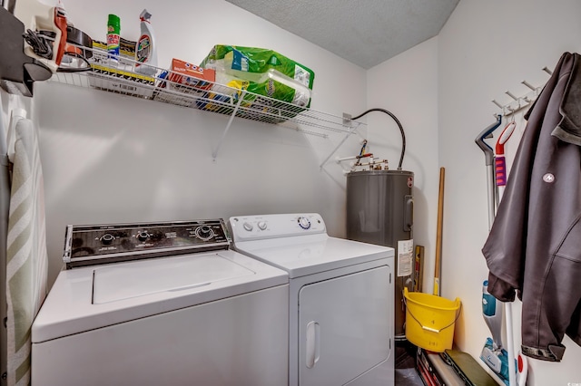 laundry room with water heater and washing machine and dryer