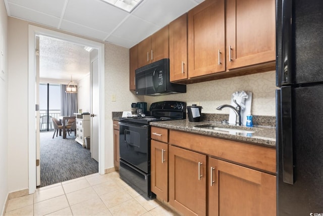 1105 S Ocean Blvd Unit 1134, Myrtle Beach, SC 29577 - kitchen with sink, dark stone countertops, light tile patterned floors, and black appliances