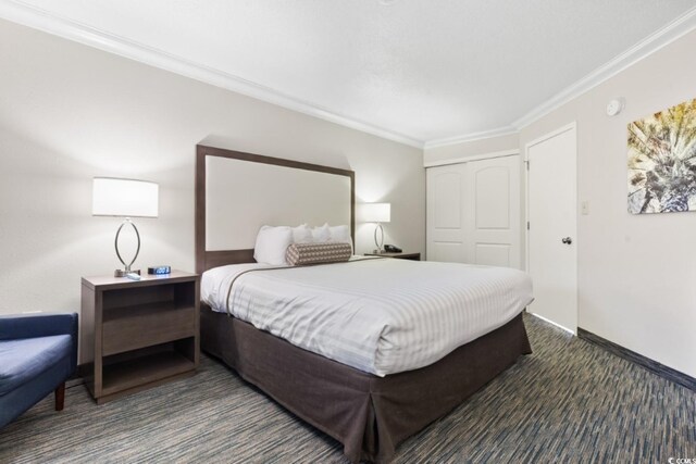 1105 S Ocean Blvd Unit 1134, Myrtle Beach, SC 29577 - bedroom featuring ornamental molding, a closet, and dark colored carpet