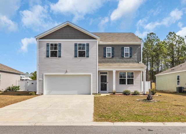 traditional home with concrete driveway, an attached garage, central AC unit, fence, and a front lawn