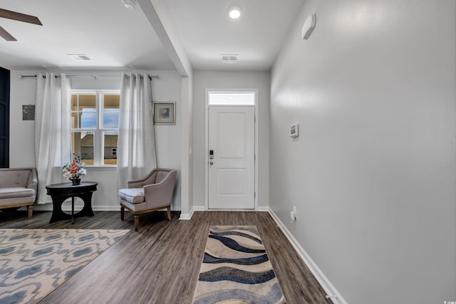 entryway with visible vents, baseboards, and wood finished floors