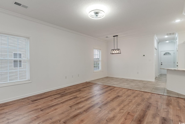 130 Lazy Willow Ln Unit 204, Myrtle Beach, SC 29588 - unfurnished dining area with baseboards, crown molding, light wood finished floors, and visible vents