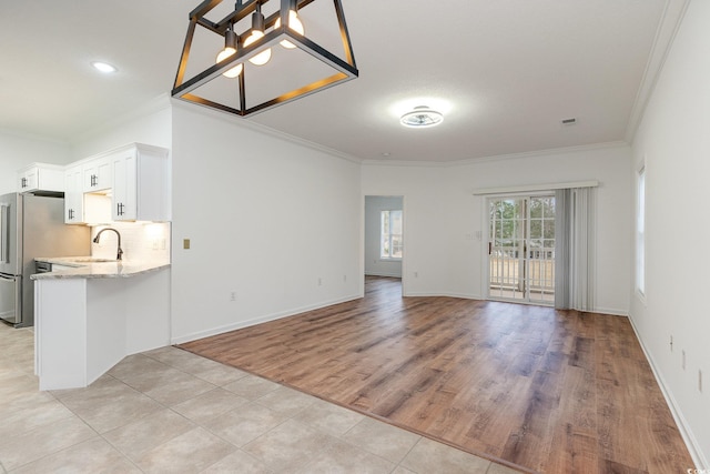 130 Lazy Willow Ln Unit 204, Myrtle Beach, SC 29588 - unfurnished living room featuring a sink, baseboards, recessed lighting, light wood-style floors, and ornamental molding