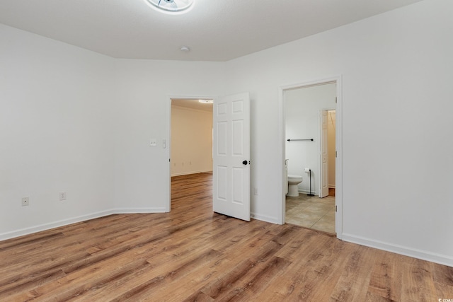 130 Lazy Willow Ln Unit 204, Myrtle Beach, SC 29588 - unfurnished bedroom with light wood-type flooring, baseboards, and connected bathroom