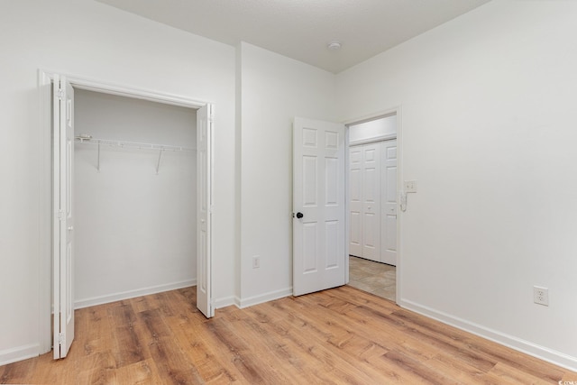 130 Lazy Willow Ln Unit 204, Myrtle Beach, SC 29588 - unfurnished bedroom featuring light wood-style flooring, a closet, and baseboards
