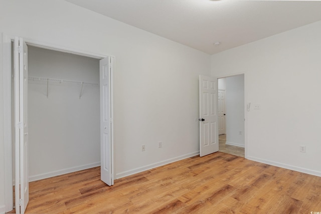 130 Lazy Willow Ln Unit 204, Myrtle Beach, SC 29588 - unfurnished bedroom with light wood-style floors, a closet, and baseboards