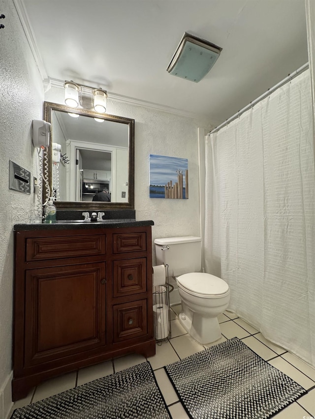 bathroom with tile patterned flooring, vanity, ornamental molding, and toilet