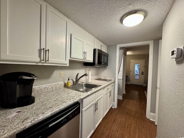 kitchen featuring sink, appliances with stainless steel finishes, dark hardwood / wood-style floors, a textured ceiling, and white cabinets