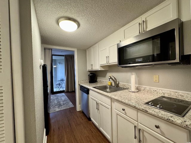 kitchen with stainless steel appliances, sink, a textured ceiling, and white cabinets