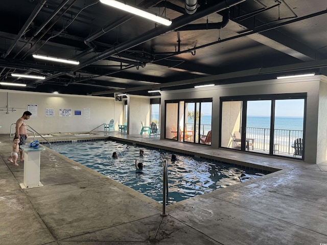 view of swimming pool with a water view