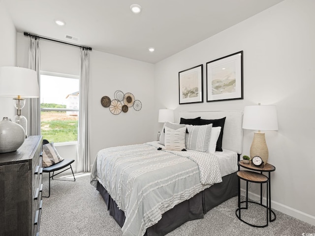 carpeted bedroom featuring recessed lighting, visible vents, and baseboards