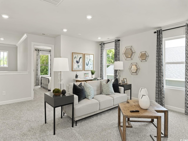 living room featuring recessed lighting, light colored carpet, visible vents, and baseboards