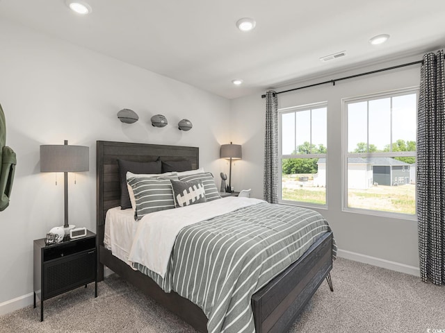 bedroom with recessed lighting, baseboards, visible vents, and light colored carpet