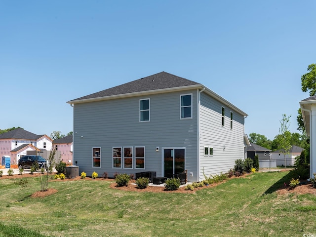 back of house featuring a yard and central AC unit