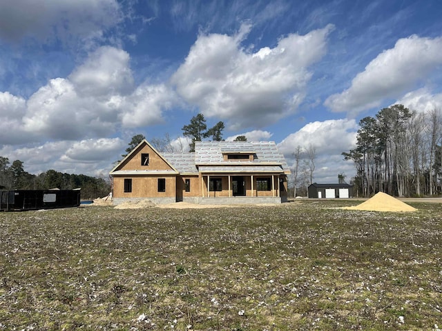 rear view of house with a yard