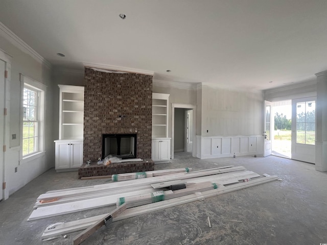 unfurnished living room featuring carpet floors, ornamental molding, and a fireplace