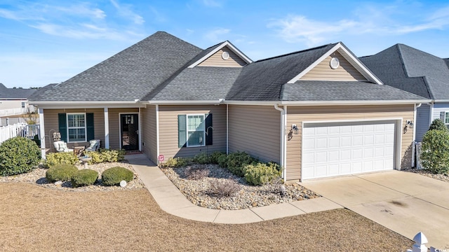 view of front facade with a garage and a porch