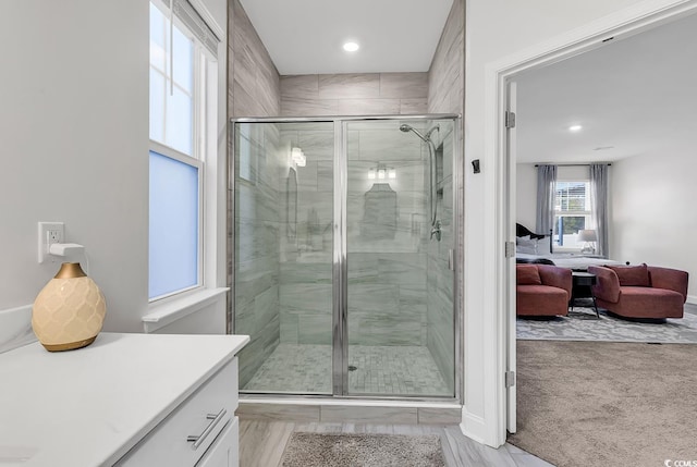 bathroom featuring vanity and an enclosed shower