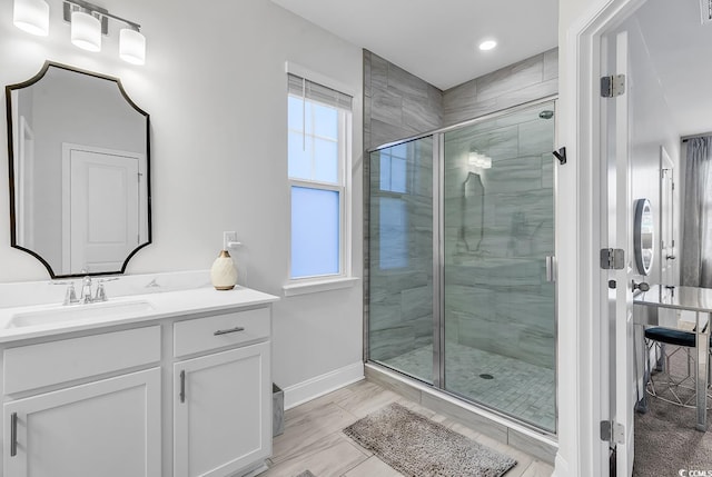 bathroom featuring an enclosed shower and vanity