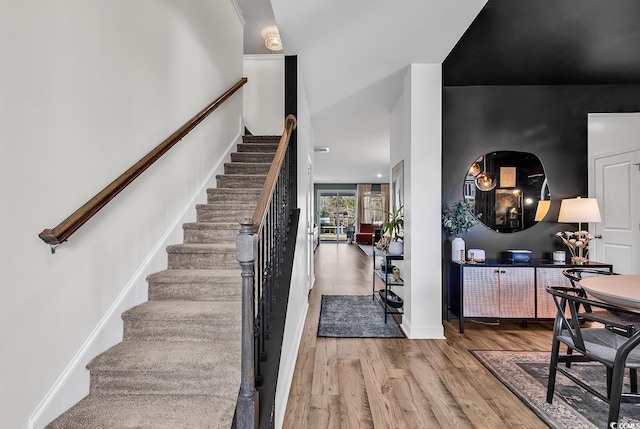 stairs featuring wood-type flooring