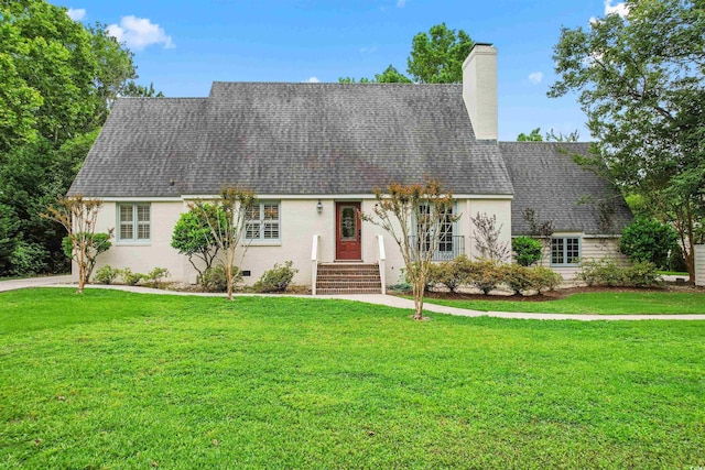 view of front of property featuring crawl space, a shingled roof, a chimney, and a front yard