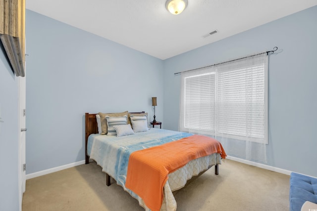 bedroom featuring light colored carpet, visible vents, and baseboards