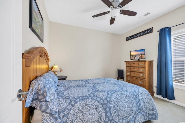 carpeted bedroom with visible vents and a ceiling fan